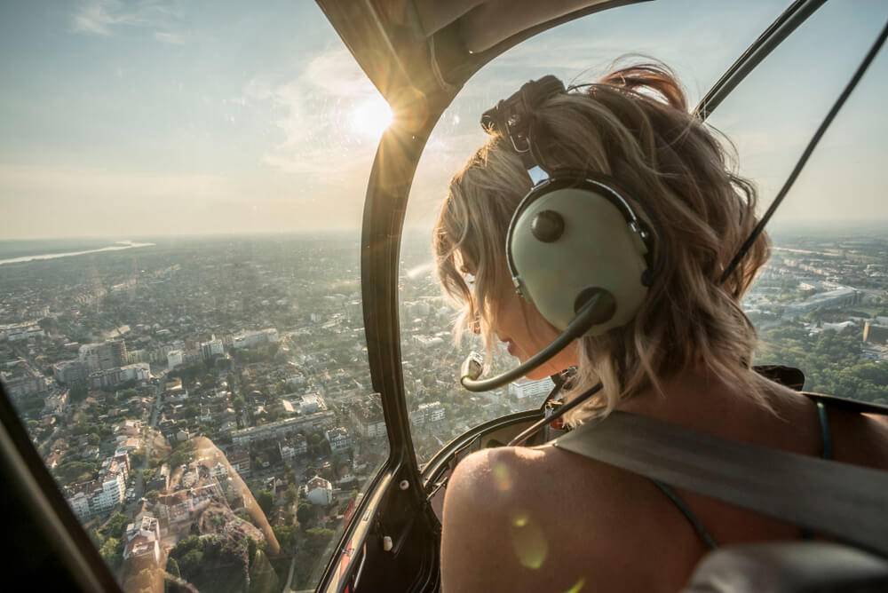 A photo of a woman on one of the best Florida helicopter tours.