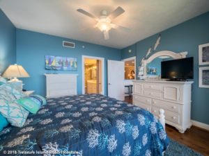 After exploring things to do in Panama City Beach with kids, relax in a comfortable bedroom like this one.