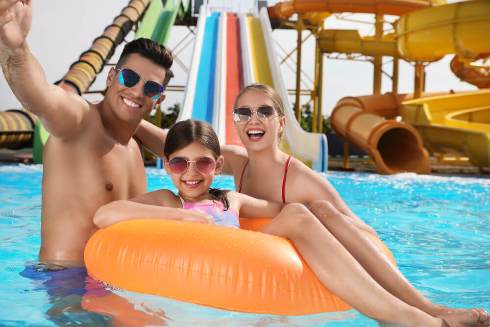 A family at a water park, one of the top things to do in Panama City Beach with kids.