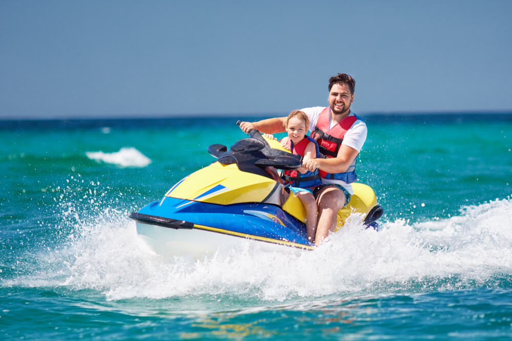 Two people on a jet ski on Panama City Beach waters.